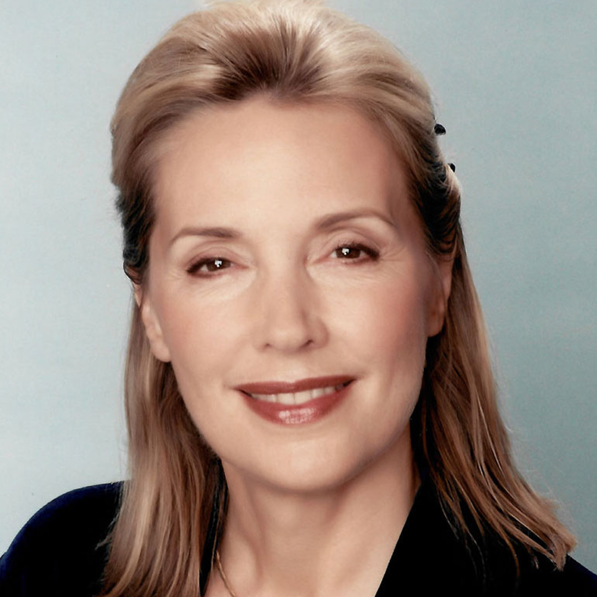 Dr. Aline LaPierre color portrait. Dr. LaPierre is a white woman with blonde hair that is half put up and is smiling and is wearing a black top.