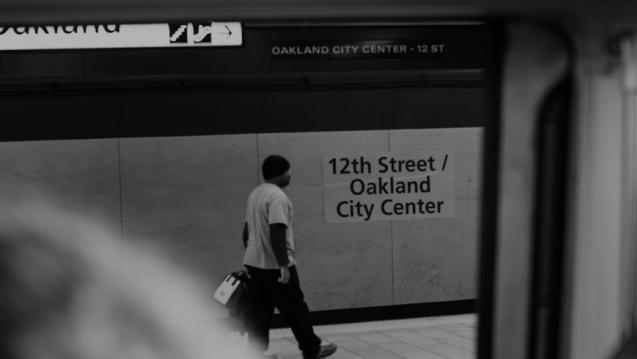 Image of the 12th street Oakland Bart station with a person walking