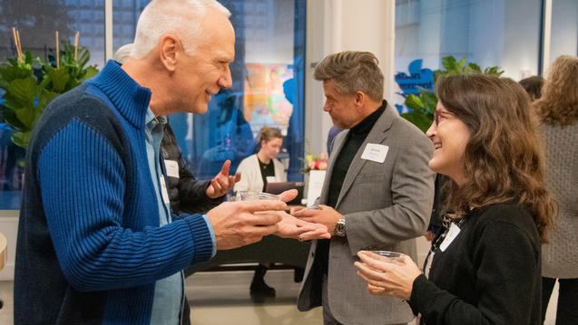 Photo of two people standing and talked animatedly