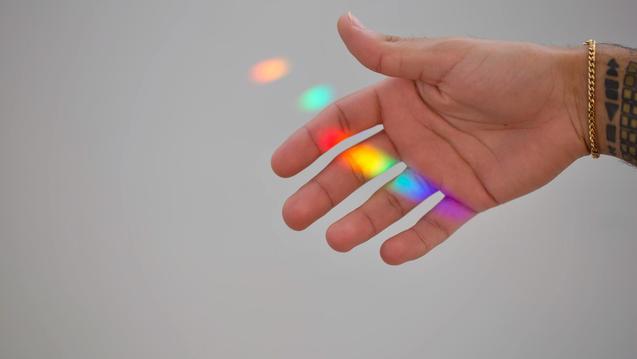 Rainbow light reflex on the hand