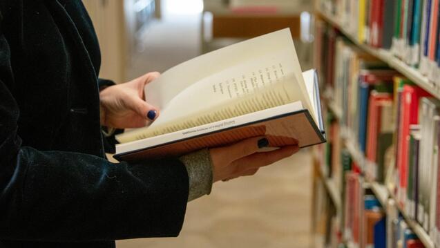 Person hold book at CIIS library