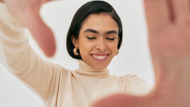 Woman framing her face with her hands