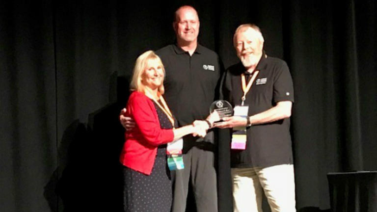 Photo of Matt Lund, and Michael Arloski awarding the Lifetime Achievement Award to Meg Jordan, chair of the Integrative Health Studies Online MA at California Institute of Integral Studies (CIIS)