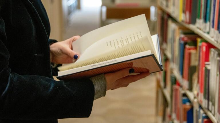 Person hold book at CIIS library