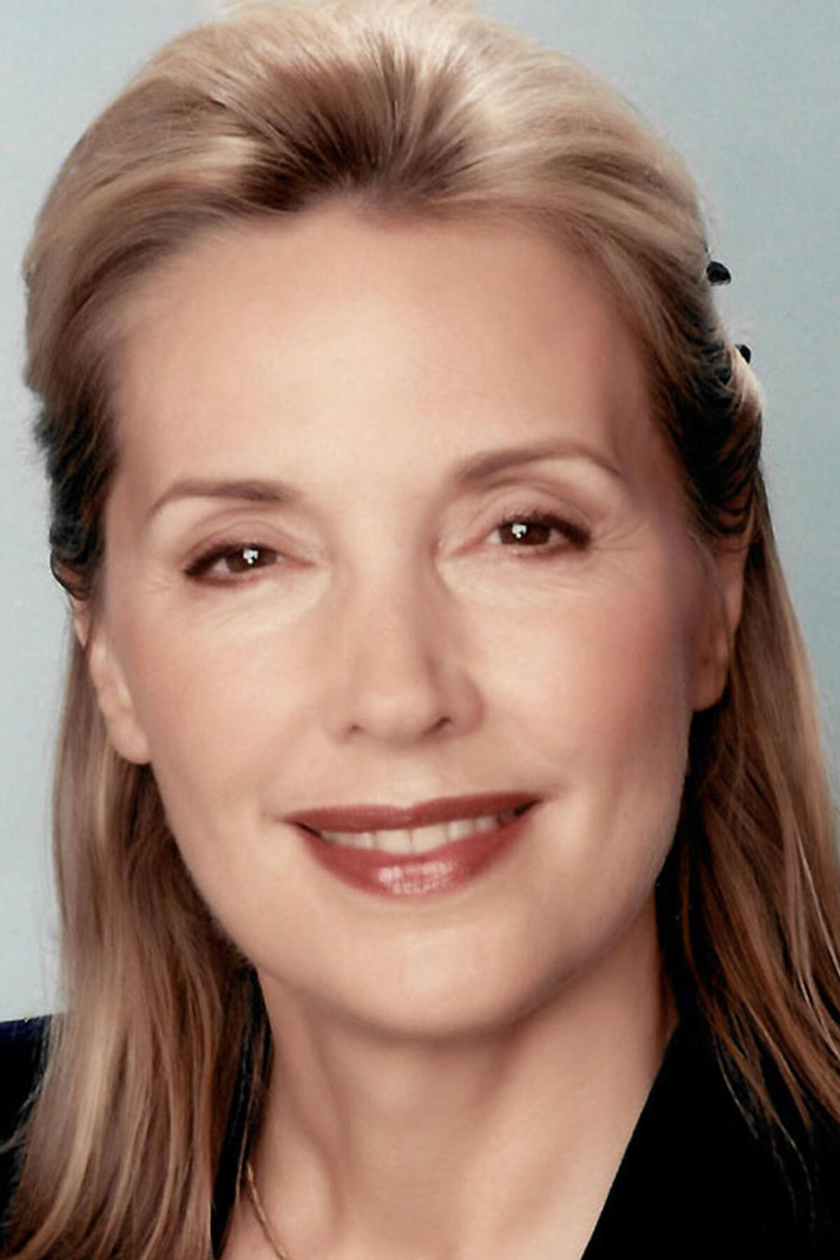 Dr. Aline LaPierre color portrait. Dr. LaPierre is a white woman with blonde hair that is half put up and is smiling and is wearing a black top.